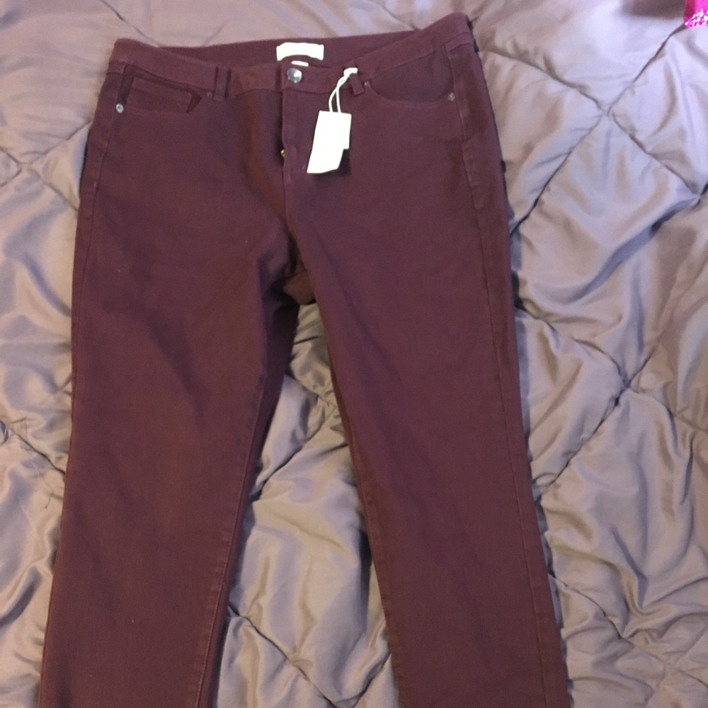 Maroon stretch jeans.